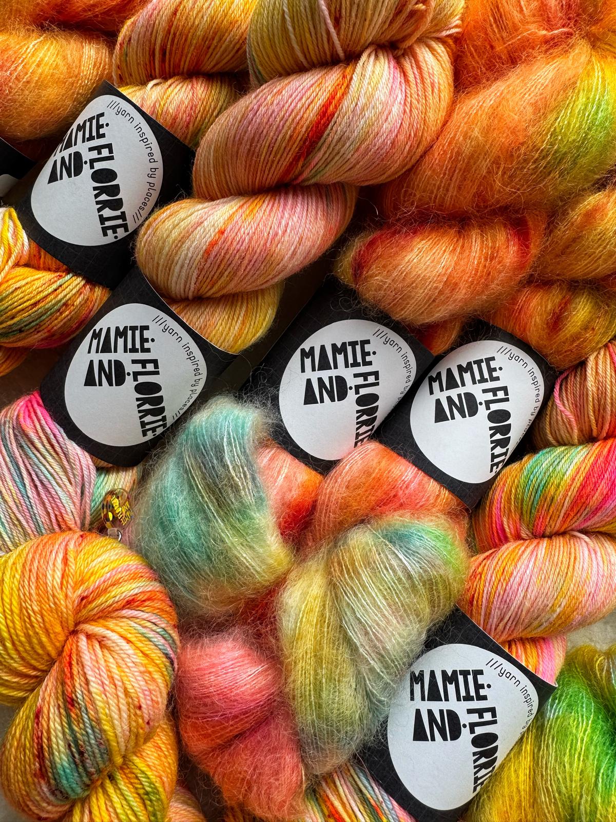 Colorful yarn skeins with 'Mamie and Florrie' labels.